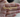  Hand holding a gold name necklace that reads "Katherine Sarmiento" with a heart design.