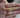  Hand holding a gold name necklace that reads "Katherine Sarmiento" with a heart design.