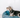 a blue dog bed with stars placed by a white wall with a pet dog in it